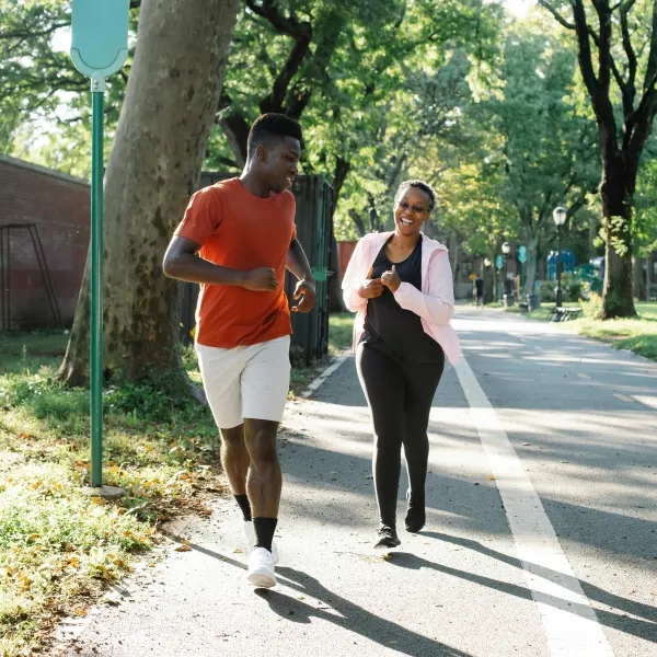 Young man and older woman running on a path