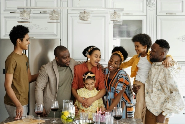 Large family smiling and laughing in a kitchen