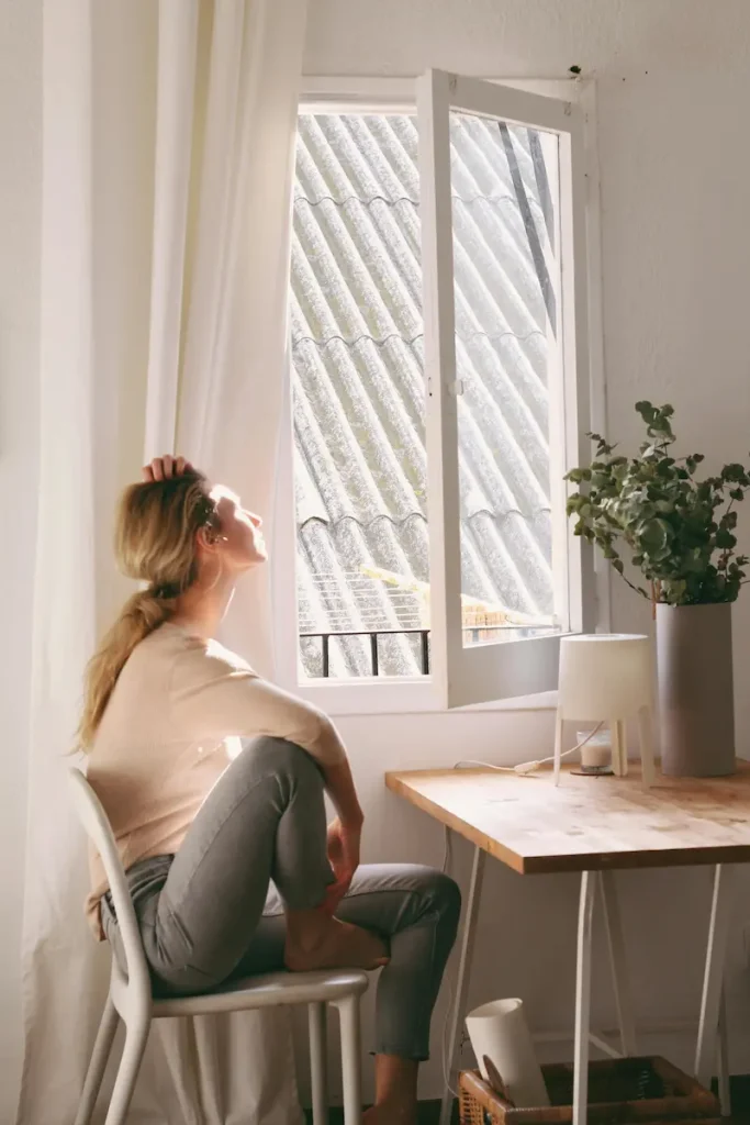 women looking out a window on a sunny day