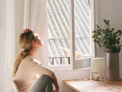 women looking out a window on a sunny day